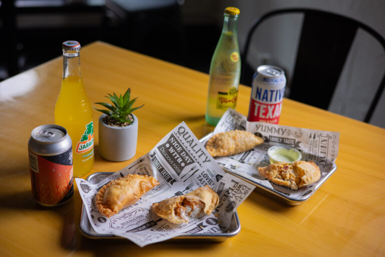 Egg rolls and canned drinks styled on a table for a Texas restaurant